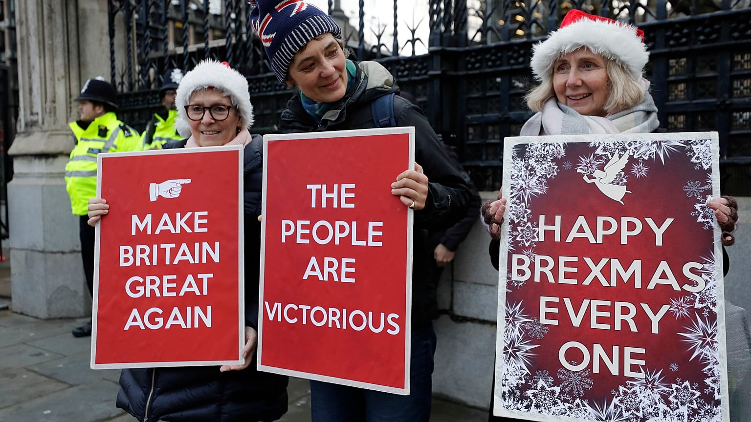 Pro Brexit demonstrators hold banners outside Parliament in London, Friday, Dec. 20, 2019. 
