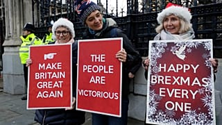 Pro Brexit demonstrators hold banners outside Parliament in London, Friday, Dec. 20, 2019. 