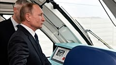 Vladimir Putin rides a train across the new bridge linking Russia and the Crimea 
