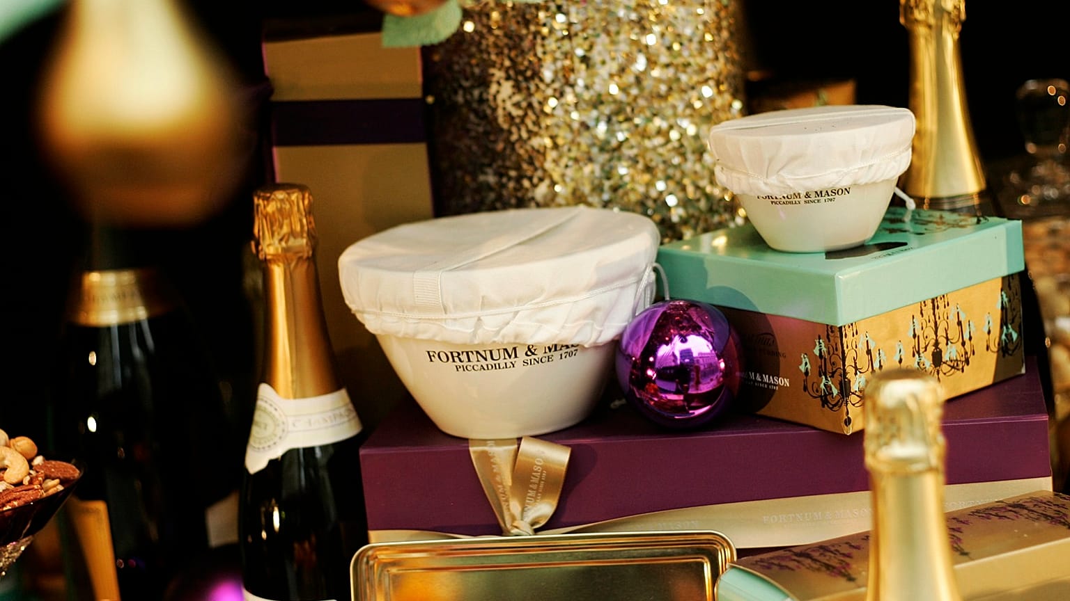 Bottles of wine and champagne, pies, decorations and Christmas puddings can be seen in the front window display of Fortnum & Mason, a central London's department store