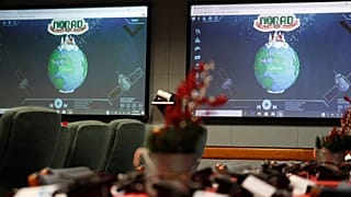 Monitors are illuminated in the NORAD Tracks Santa center at Peterson Air Force Base 