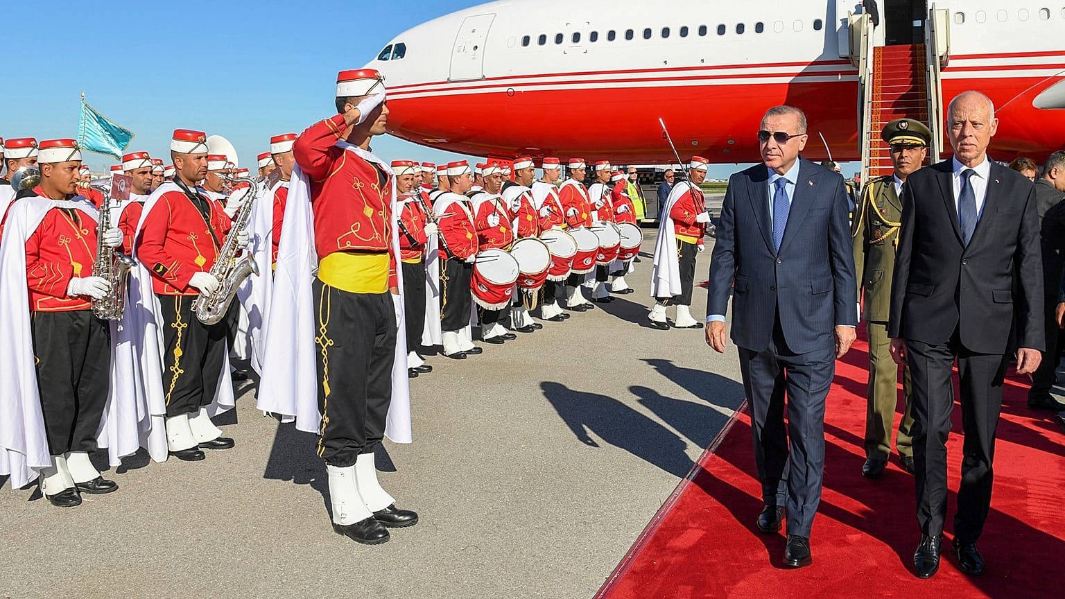 الرئيس التركي رجب طيب أردوغان، والرئيس التونسي قيس سعيد، برفقة حرس الشرف العسكري في مطار تونس العاصمة.  