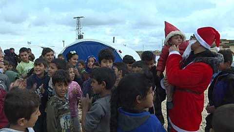 Activists distribute Christmas presents at camp for displaced Syrian children