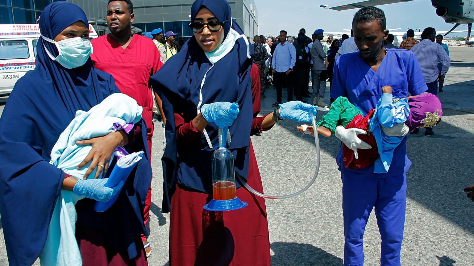 Medical personnel carry wounded children to be airlifted to the Turkish capital for treatment after they were injured in Saturday's car bomb blast in Mogadishu, Somalia. 
