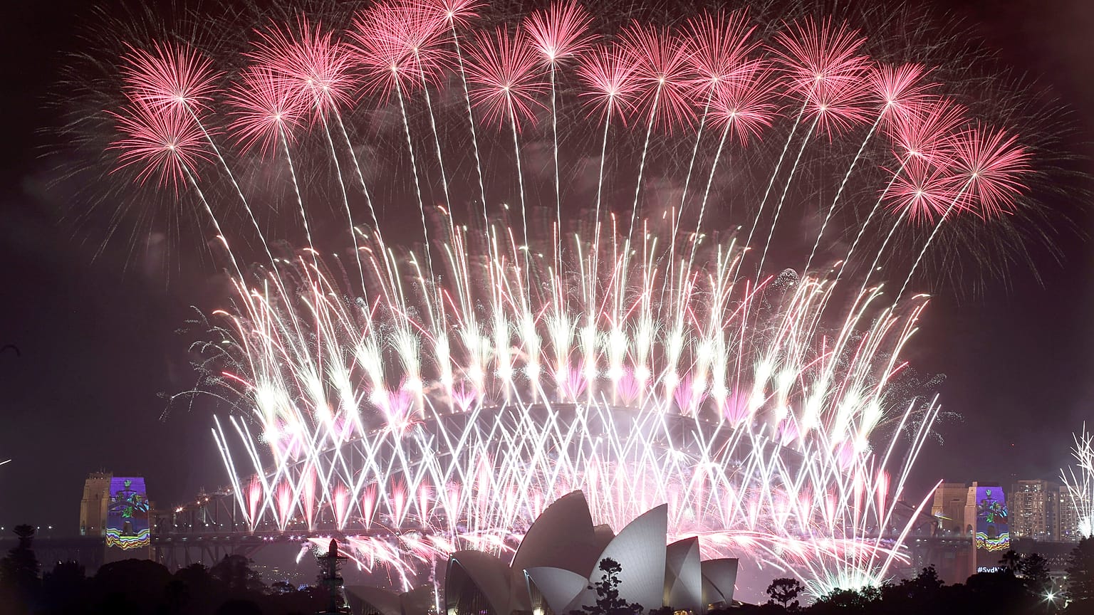 In this Sunday, Jan. 1, 2017 photo, fireworks explode over the Sydney Opera House and Harbour Bridge as New Year's celebrations are underway in Sydne. (AP Photo/Rick Rycroft, 