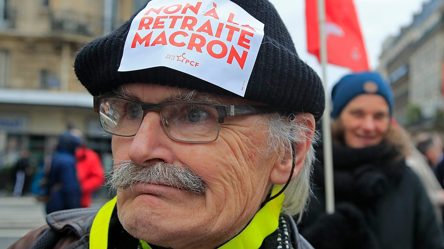 A demonstrators wears a sticker on his hat that reads, "no to Macron's pension reform during a protest in Paris, Saturday, Dec. 28, 2019. 
