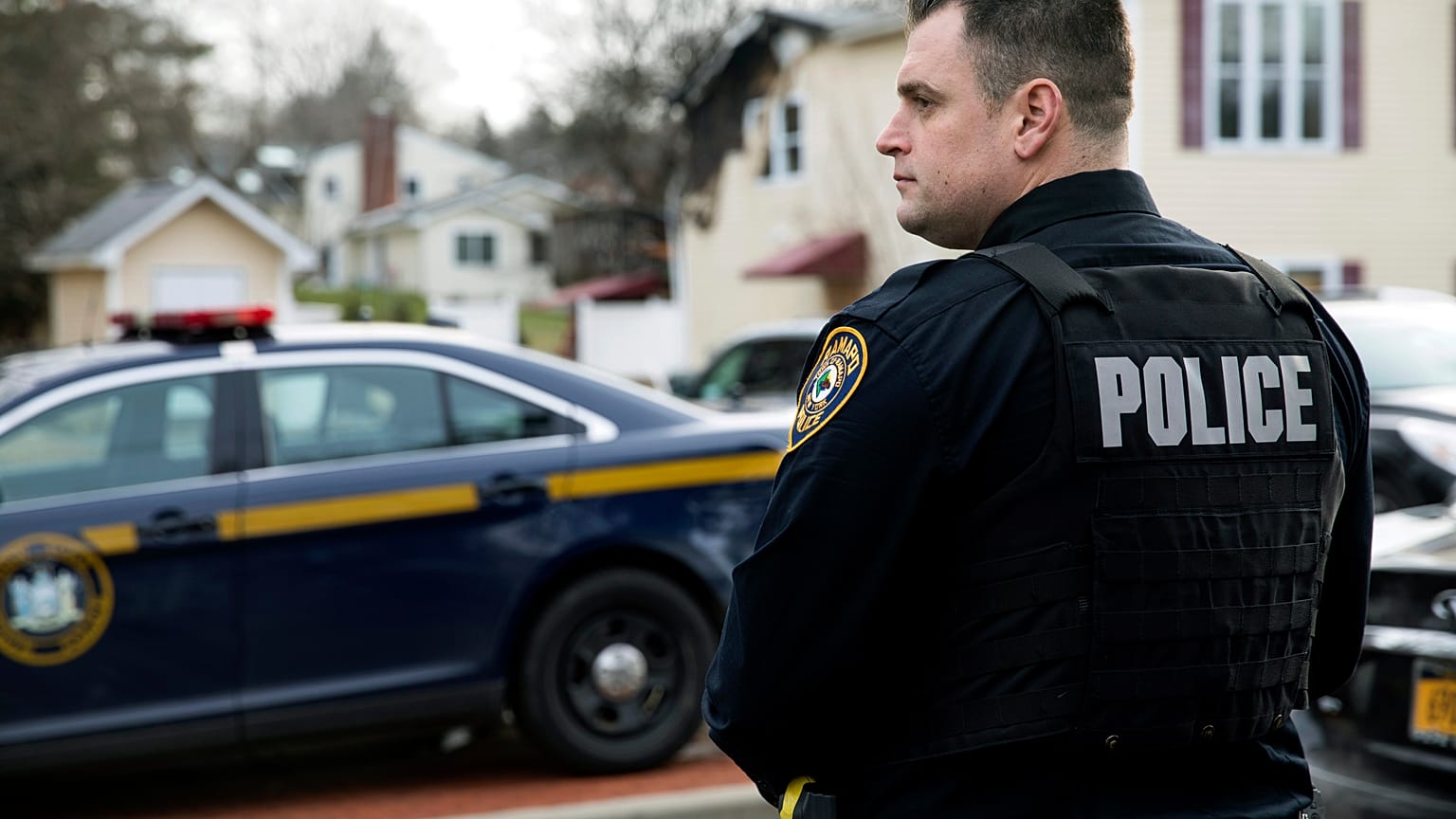 A Ramapo police officer directs traffic outside of a rabbi's residence in Monsey, N.Y.
