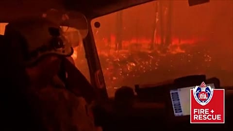 Terrifying moment as Australian firefighters drive through flames