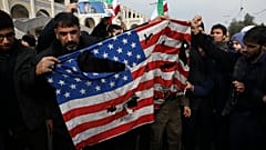 Protesters burn a U.S. flag during a demonstration over the U.S. airstrike in Iraq that killed Iranian Revolutionary Guard Gen. Qassem Soleimani, in Tehran, Iran, Jan. 3, 2020