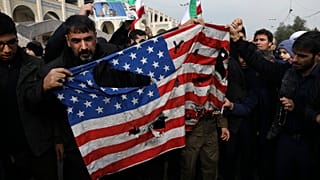 Protesters burn a U.S. flag during a demonstration over the U.S. airstrike in Iraq that killed Iranian Revolutionary Guard Gen. Qassem Soleimani, in Tehran, Iran, Jan. 3, 2020