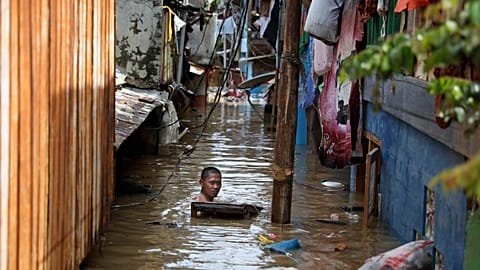 A man swims in flood water in a low-income neighborhood in Jakarta, Indonesia. 2 January 2020. 