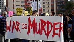 Activists gather in Pershing Square to protest recent U.S. military actions in Iraq (AP Photo/Damian Dovarganes)