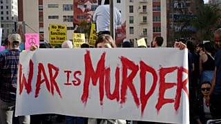 Activists gather in Pershing Square to protest recent U.S. military actions in Iraq (AP Photo/Damian Dovarganes)