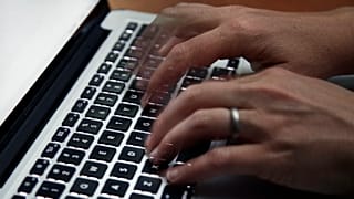 Fingers type on a laptop keyboard Monday, June 19, 2017, in North Andover, Mass.