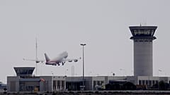 An aircraft take off from Larnaca airport by a tower control is seen at right. Cyprus