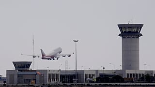 An aircraft take off from Larnaca airport by a tower control is seen at right. Cyprus