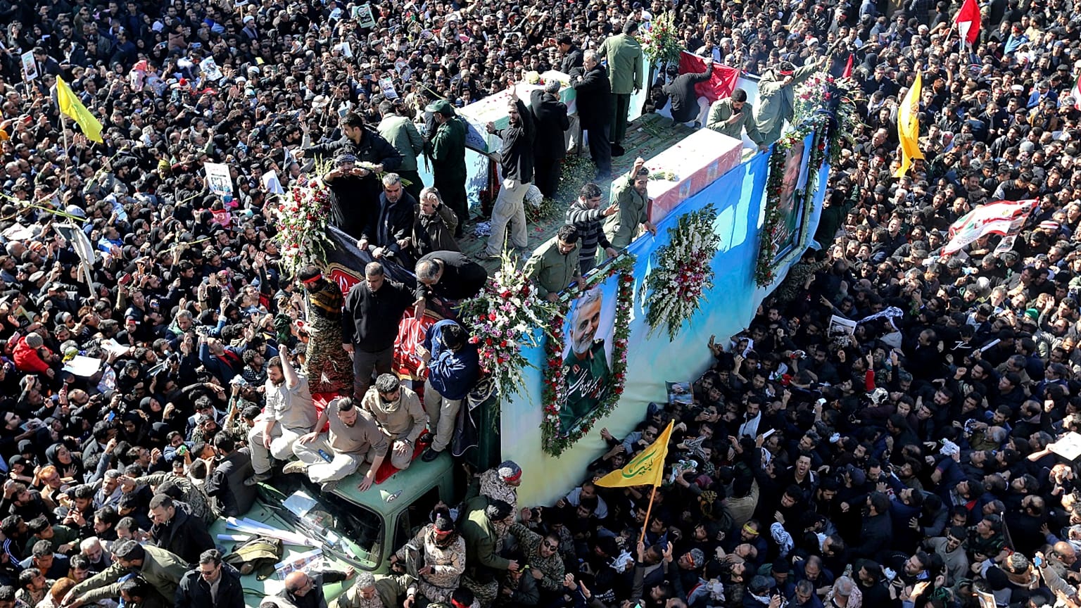 Coffins of Gen. Qassem Soleimani and others who were killed in Iraq by a U.S. drone strike, are carried on a truck during a funeral procession, in the city of Kerman, Iran