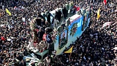 Coffins of Gen. Qassem Soleimani and others who were killed in Iraq by a U.S. drone strike, are carried on a truck during a funeral procession, in the city of Kerman, Iran