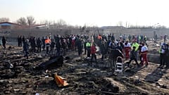 Rescue teams work at the scene after a Ukrainian plane carrying 176 passengers crashed near Imam Khomeini airport in the Iranian capital Tehran on January 8, 2020.