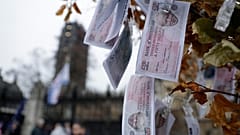 Fake 350 million pound notes bearing the face of British Prime Minister Boris Johnson, hang from a "Magic Money Tree" placed by anti-Brexit protesters