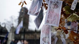 Fake 350 million pound notes bearing the face of then Prime Minister Boris Johnson, placed by anti-Brexit protesters outside the Houses of Parliament in London, Jan. 7, 2020.