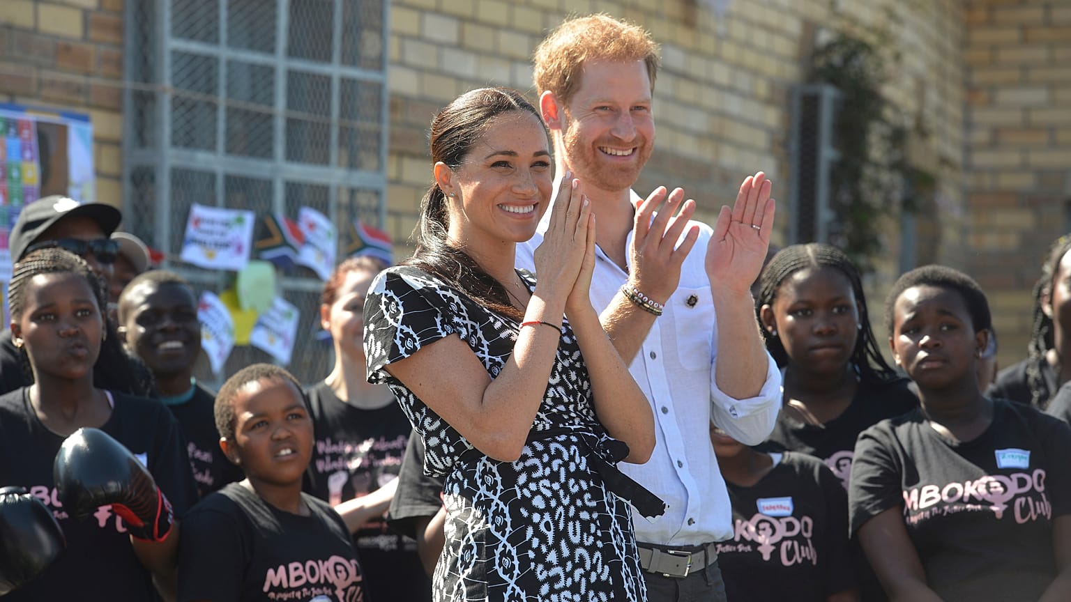 Britain's Prince Harry and Meghan, Duchess of Sussex greet youths on a visit to the Nyanga Methodist Church in Cape Town, South Africa on September 23, 2019.