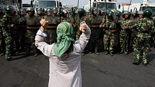 Çin paramiliter polisini protesto eden Uygur kadın. Urumçi (arşiv)
