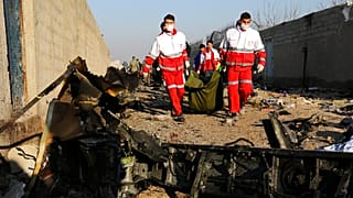 Rescue workers carry the body of a victim of an Ukrainian plane crash in Iran