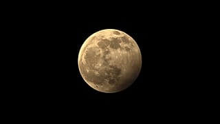 The full moon during the penumbral lunar eclipse is seen on the outskirts of Chandigarh