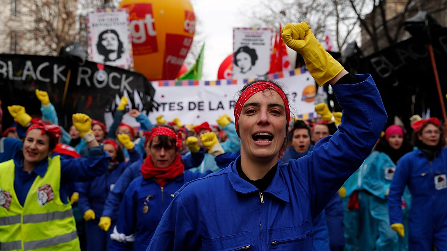 Women sing against French President Emmanuel Macron, who is mocked at center, during a demonstration, Saturday, Jan. 11, 2020 in Paris. 