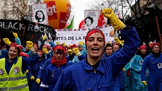 Women sing against French President Emmanuel Macron, who is mocked at center, during a demonstration, Saturday, Jan. 11, 2020 in Paris. 