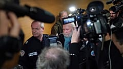 Former French priest Bernard Preynat, center, arrives at the Lyon court house, central France, Monday Jan.13, 2020.