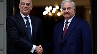 Libyan Gen. Khalifa Hafter, right, and Greek Foreign Minister Nikos Dendias shake hands before their meeting in Athens, Friday, Jan. 17, 2020