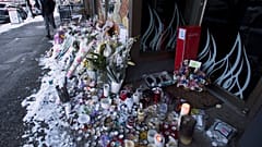Snow-covered flowers and candles are seen outside of the family bakery of Ayeshe Pourghadheri and her daughter Fatemah Pasavand in North Vancouver, B.C.