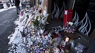 Snow-covered flowers and candles are seen outside of the family bakery of Ayeshe Pourghadheri and her daughter Fatemah Pasavand in North Vancouver, B.C.