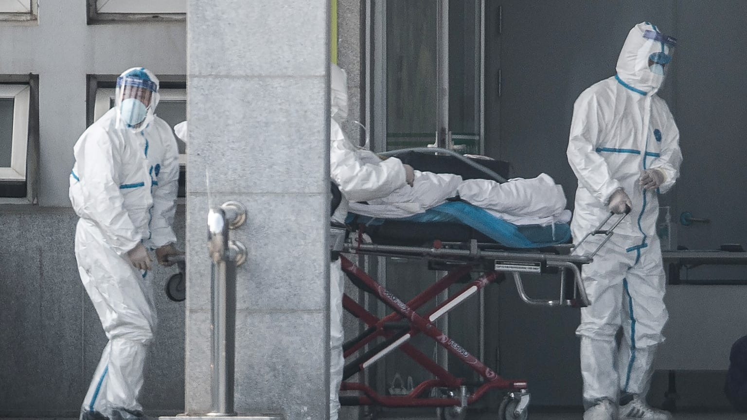 Medical staff members carry a patient into the Jinyintan hospital, where patients infected by a mysterious SARS-like virus are being treated, in Wuhan China January 18, 2020