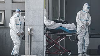 Medical staff members carry a patient into the Jinyintan hospital, where patients infected by a mysterious SARS-like virus are being treated, in Wuhan China January 18, 2020