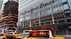 Traffic passes in front of The New York Times building in New York