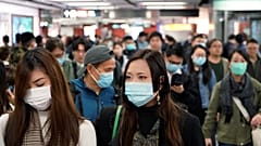 FILE PHOTO: Passengers wear masks to prevent an outbreak of a new coronavirus in a subway station, in Hong Kong, Wednesday, Jan. 22, 2020. 