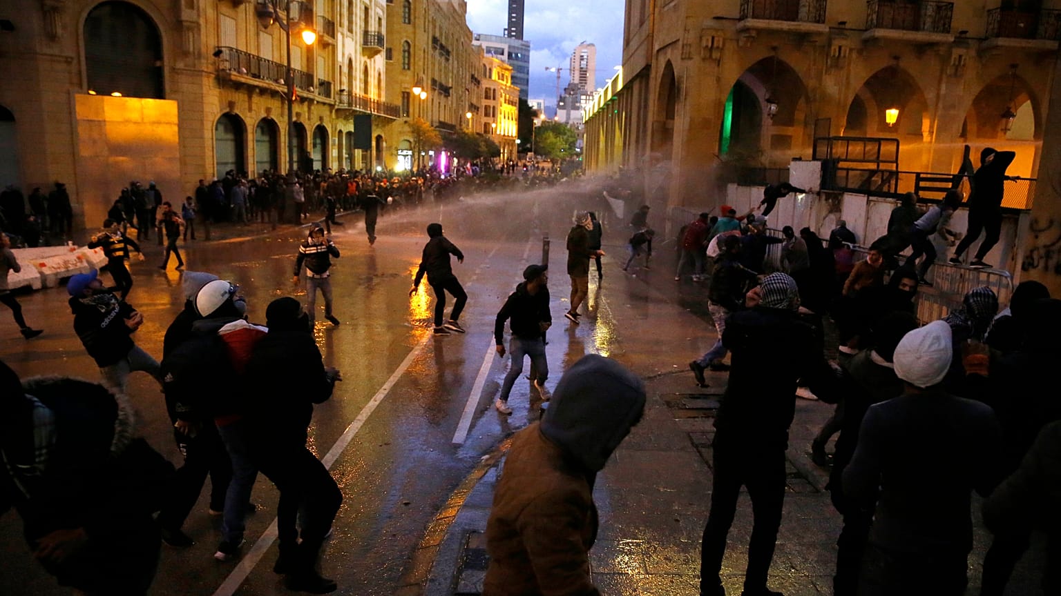 Anti-government protesters clash with the riot police during ongoing protests in Beirut, Lebanon, Wednesday, Jan. 22, 2020.