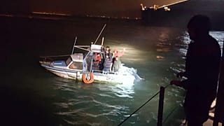 Migrants aboard a boat after being intercepted by French authorities, off the port of Dunkirk, northern France, Tuesday, Nov. 27, 2018. 