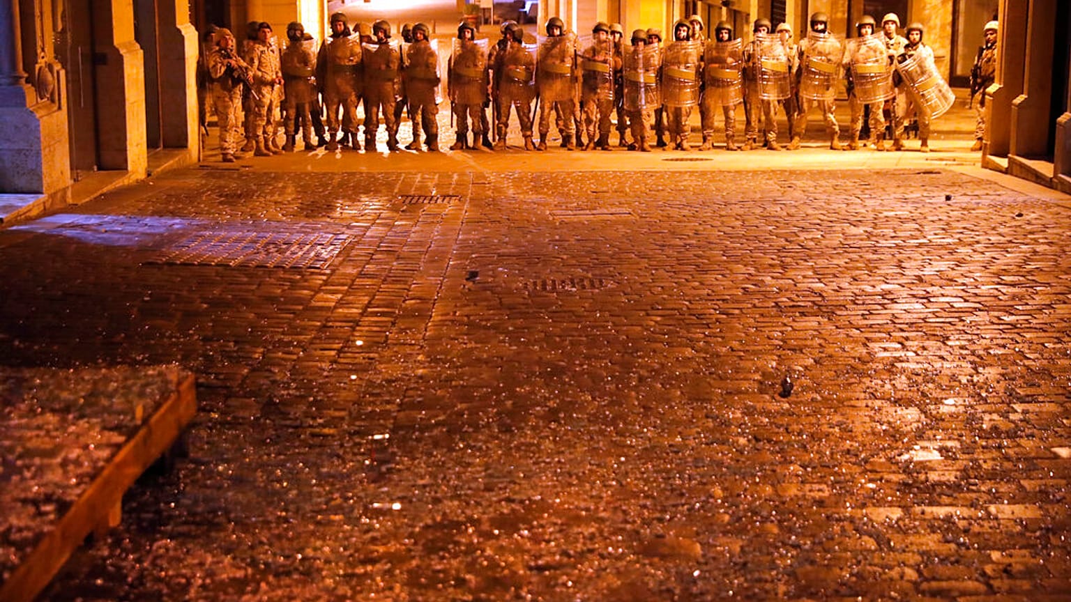 Lebanese army soldiers deploy on a street where anti-government protesters clash with riot police, during a protest against the new government, in downtown Beirut, Lebanon, We