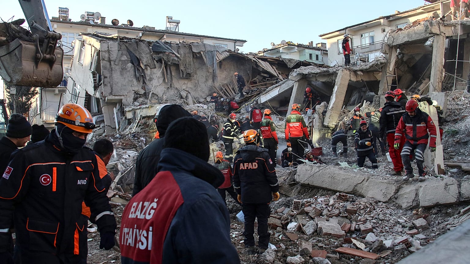 Rescue workers work to save people trapped under debris in Elazig, eastern Turkey, Sunday, Jan. 26, 2020.