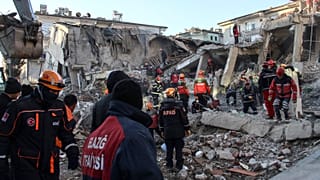 Rescue workers work to save people trapped under debris in Elazig, eastern Turkey, Sunday, Jan. 26, 2020.