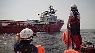 A rescuer waits for orders from the Ocean Viking in the Mediterranean Sea, Tuesday, Sept. 17, 2019. 