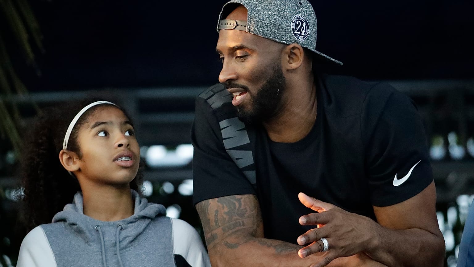 In this July 26, 2018 file photo former Los Angeles Laker Kobe Bryant and his daughter Gianna watch the U.S. national championships swimming meet in Irvine, Calif. 