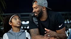 In this July 26, 2018 file photo former Los Angeles Laker Kobe Bryant and his daughter Gianna watch the U.S. national championships swimming meet in Irvine, Calif. 