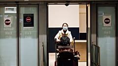 A traveler coming from Beijing and wearing a mask arrives at Charles de Gaulle airport, Paris. 