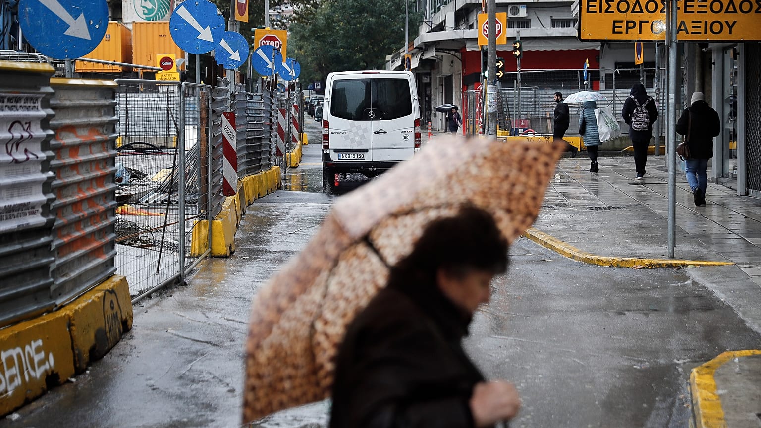 Μία γυναίκα περπατάει στο κέντρο της Θεσσαλονίκης μία βροχερή χειμωνιάτικη ημέρα (αρχείου)
