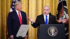 Israeli Prime Minister Benjamin Netanyahu, with US President Donald Trump, speaks during an announcement of Trump's Middle East peace plan in White House on January 28, 2020